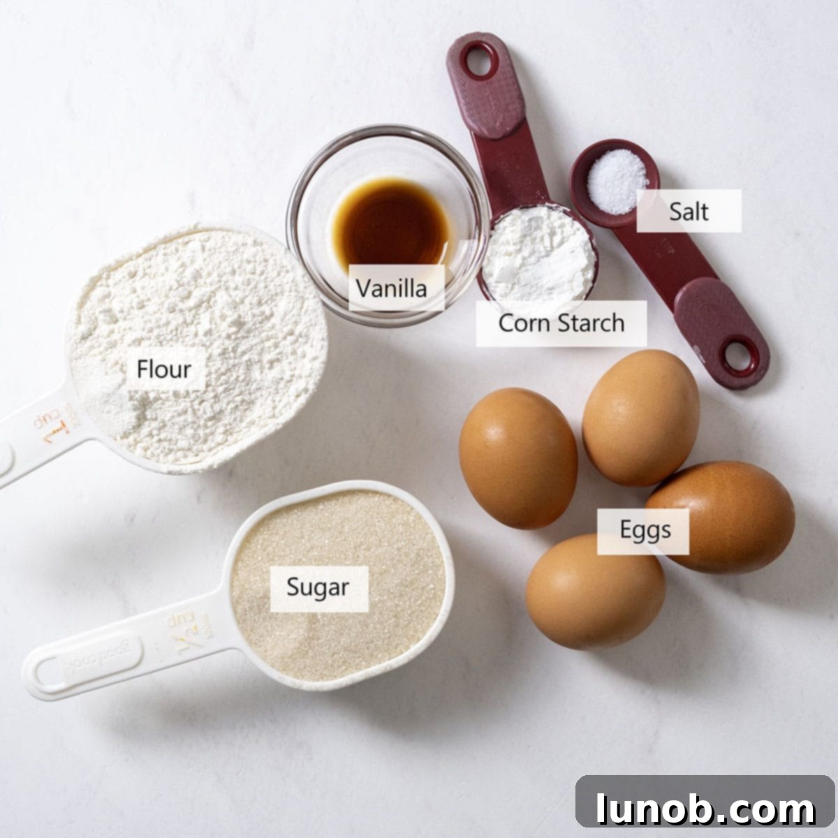 Ingredients for the ladyfingers recipe laid out on a table.