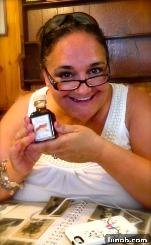 Blogger holding a bottle of traditional balsamic vinegar in Modena