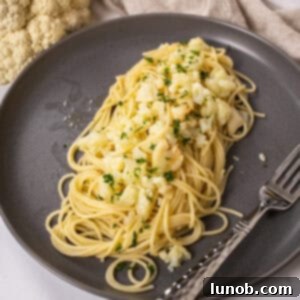 Roasted Cauliflower Pasta 9 spaghetti with cauliflower plated on a dish garnished with parsley.