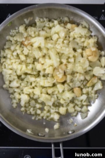 Roasted Cauliflower Pasta 6 cauliflower added to saute pan with garlic.