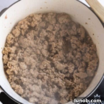Soul-Warming Sausage and Lentil Soup 4 Browning sweet Italian sausage in a large Dutch oven, creating a flavorful base for the soup.