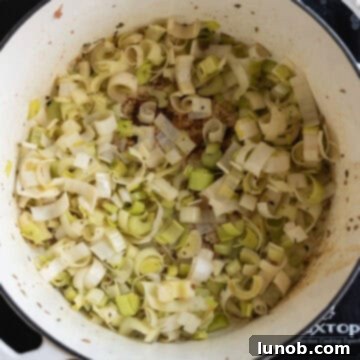 Soul-Warming Sausage and Lentil Soup 5 Sautéing chopped leeks and celery in olive oil, softening the aromatics for the soup base.