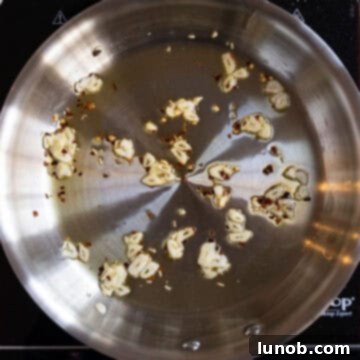 Garlic and crushed red pepper sauteing in olive oil.