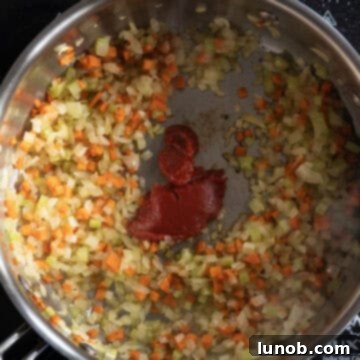 Authentic Italian Lentils 5 Tomato paste caramelizing directly in a hot saucepan.