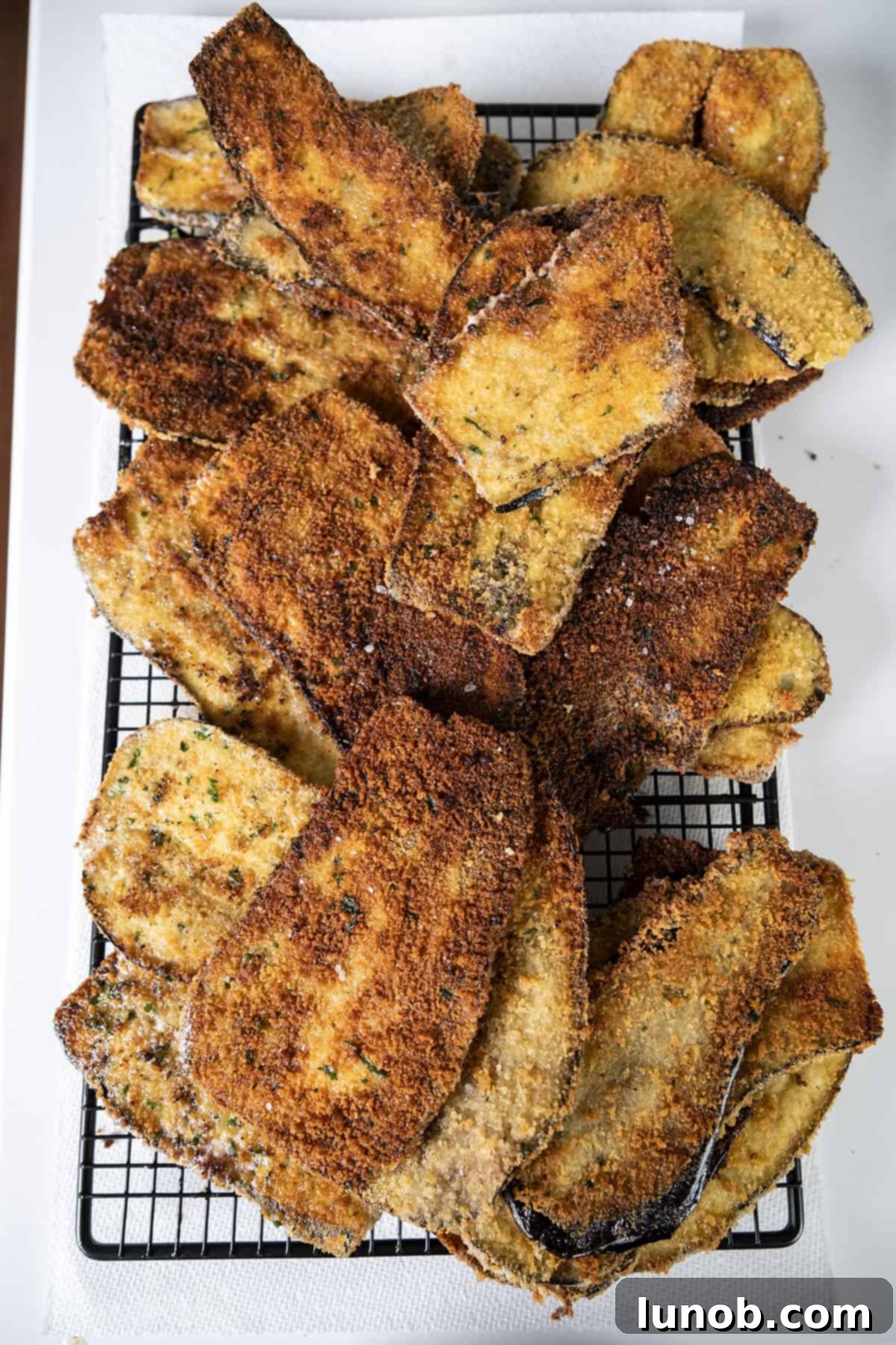 Fried eggplant on a cooling rack.