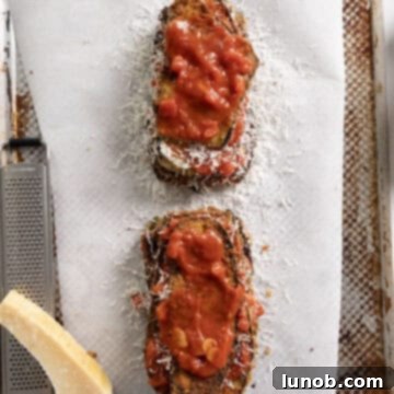 Eggplant piled into layers of eggplant, marinara, and parmesan.