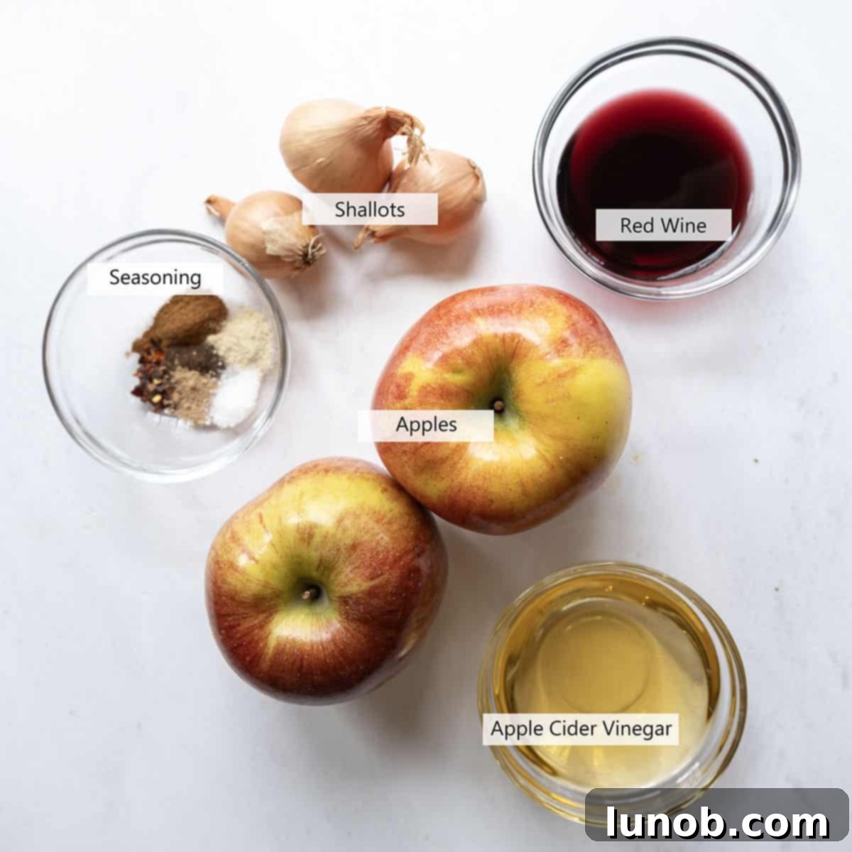 Golden Apple & Spice Chutney 3 A collection of fresh ingredients for spiced apple chutney, including chopped apples, shallots, and various spices.