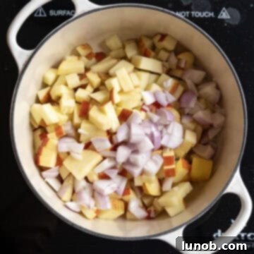Golden Apple & Spice Chutney 5 Chopped apples and shallots sautéing in olive oil in a dutch oven.