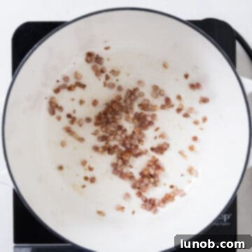 Traditional Italian Pasta Fagioli 4 Diced pancetta frying in a large Dutch oven until perfectly crispy and golden.