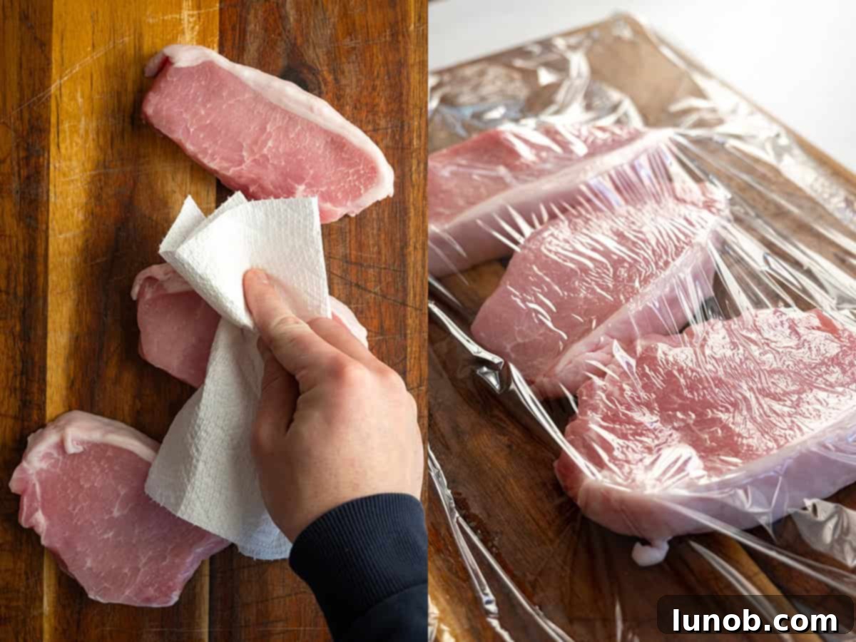 Ultimate Cast Iron Boneless Pork Chops 4 Raw boneless pork chops being dried with paper towels and tenderized with a meat mallet on a cutting board.