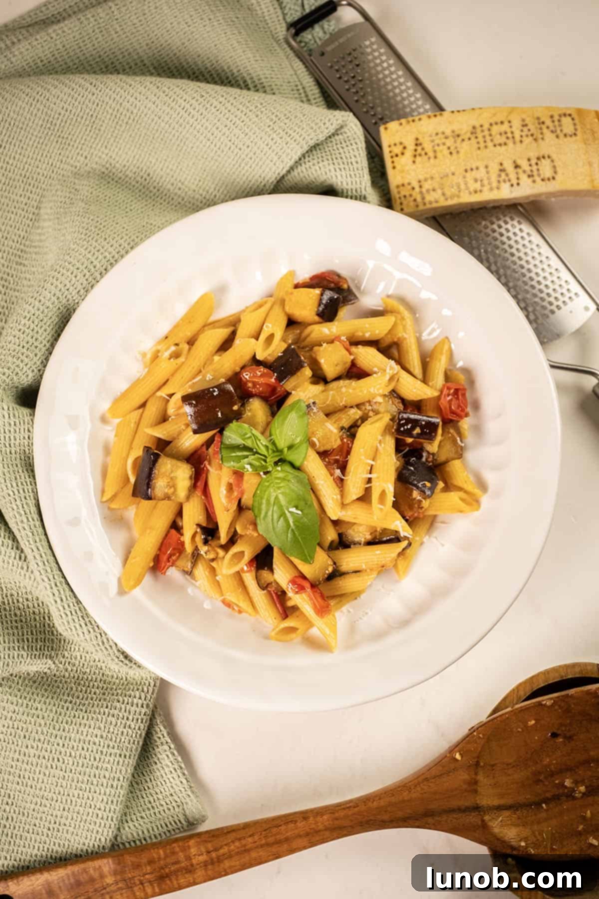 Rustic Eggplant Tomato Pasta 2 Pasta with eggplant and cherry tomatoes in a bowl garnished with fresh basil.