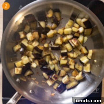 Rustic Eggplant Tomato Pasta 5 Eggplant frying in a pan.