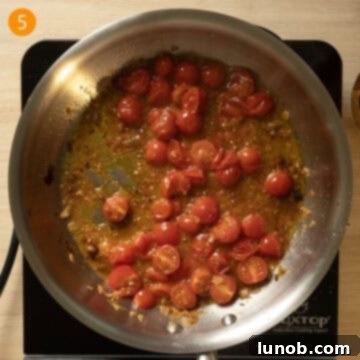 Rustic Eggplant Tomato Pasta 8 Cherry tomatoes breaking down in a pan and wine sauce thickening.