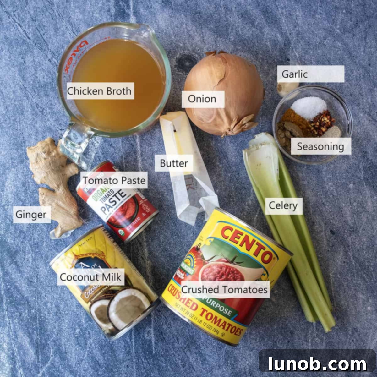 Velvet Butter Chicken Soup 4 Various ingredients for the butter chicken soup, including coconut milk, crushed tomatoes, onions, celery, and a medley of spices.