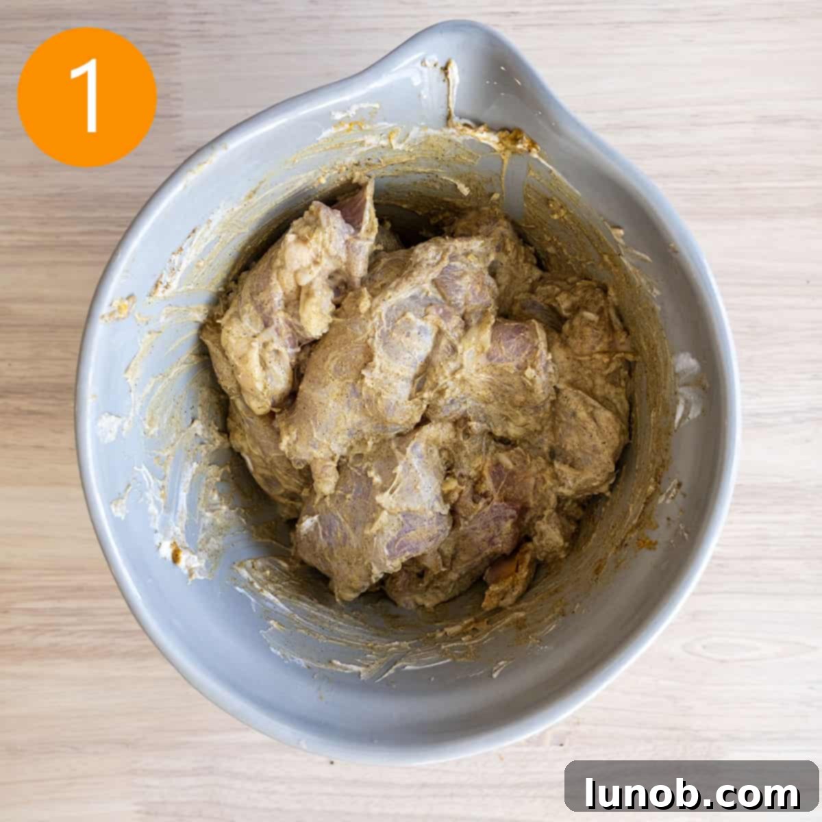 Velvet Butter Chicken Soup 5 Boneless chicken thighs marinating in a mixture of Greek yogurt and Indian spices in a bowl.