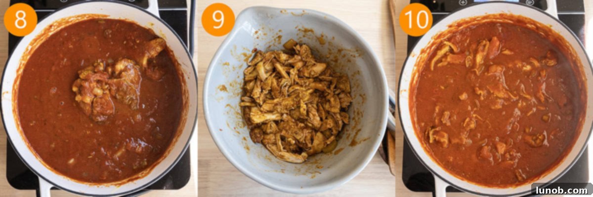 Velvet Butter Chicken Soup 9 Cooked chicken thighs simmering in the soup, then being removed and shredded with two forks.