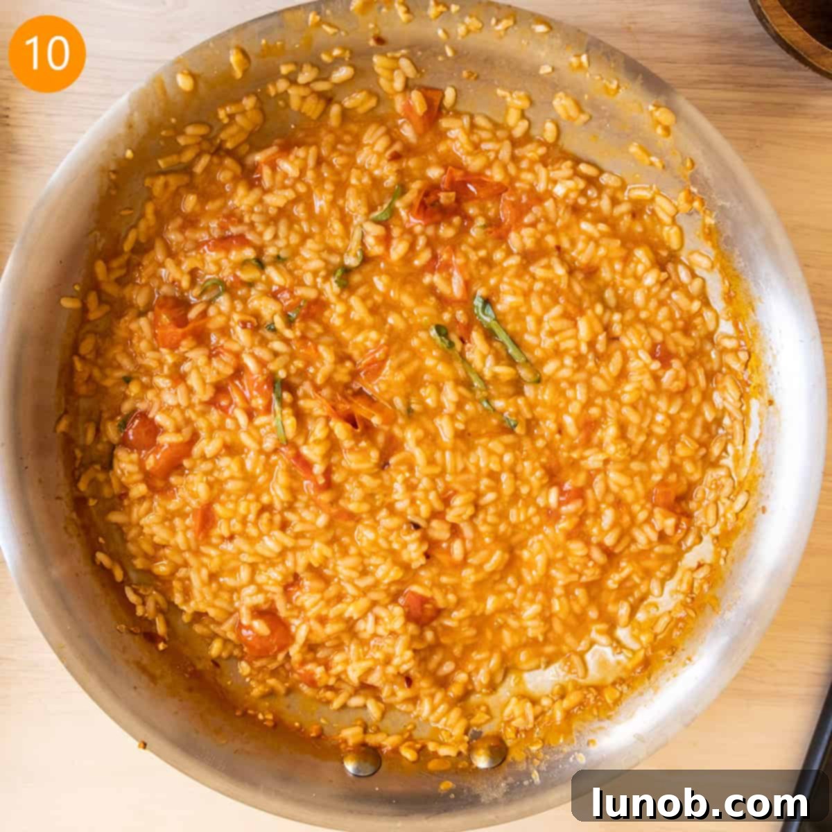 Velvet Tomato Risotto 8 Finished risotto in pan with slight runniness to sauce to eventually be absorbed.