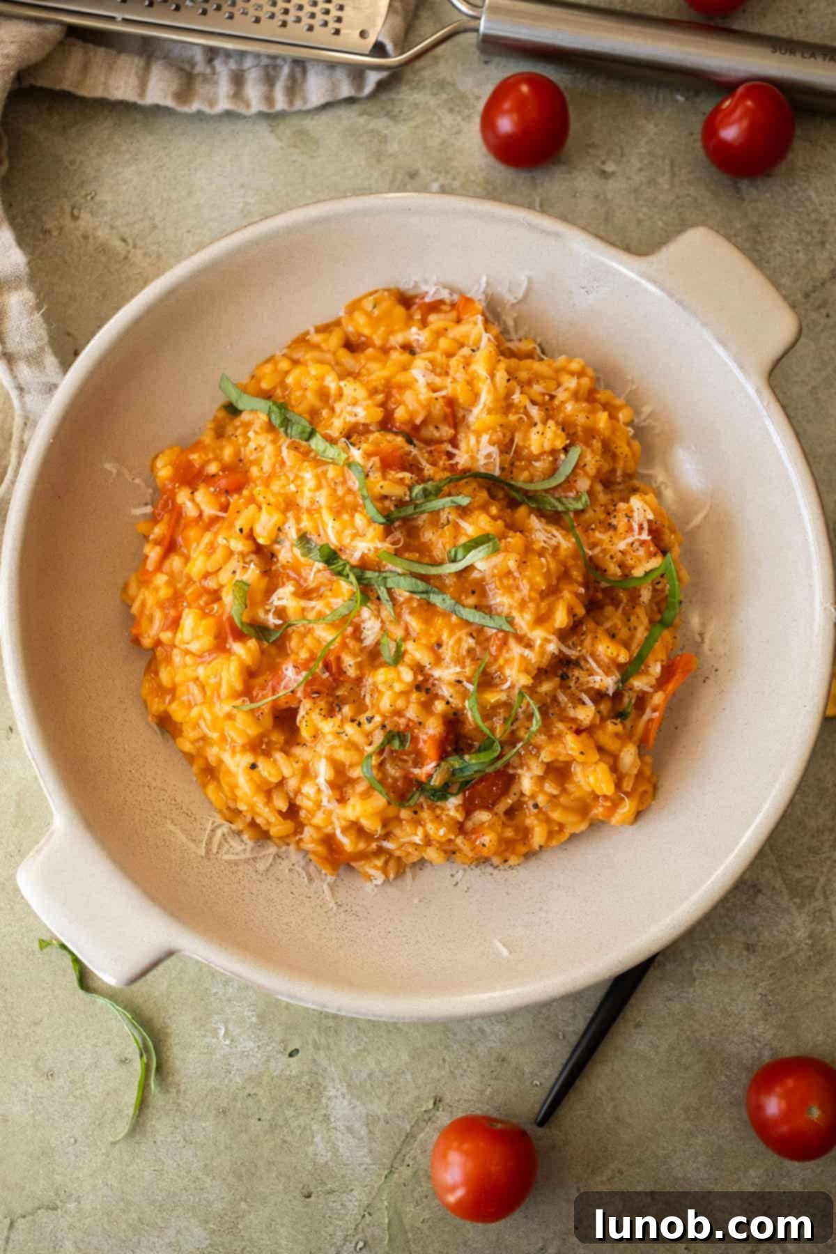 Velvet Tomato Risotto 9 Creamy cherry tomato risotto in a bowl topped with fresh basil.