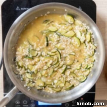 Chicken broth added to saucepan.