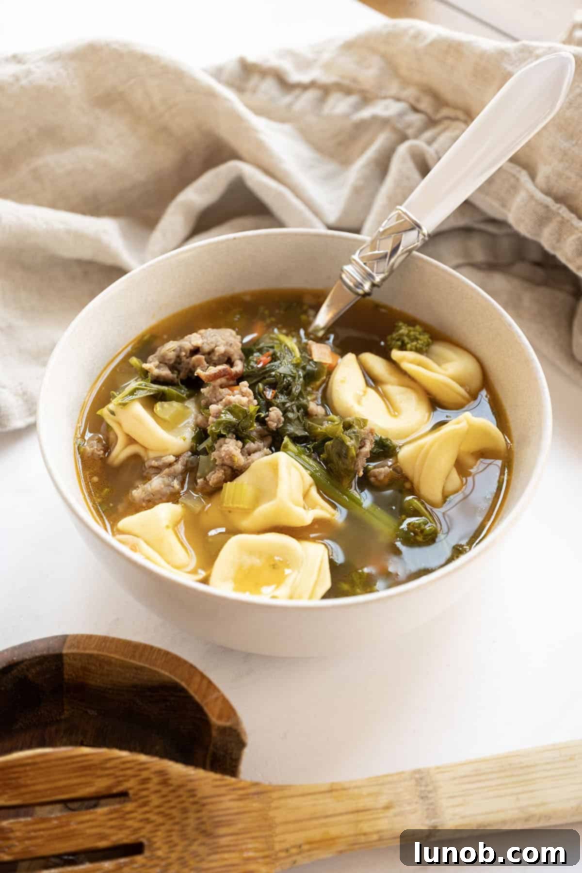 Hearty Broccoli Rabe and Tortellini Soup 11 Sausage and broccoli rabe soup with tortellini in a dutch oven.