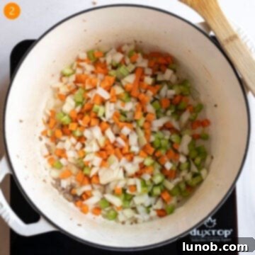 Sauteing carrots, celery, and onion in dutch oven.