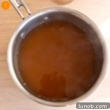 Warming chicken broth in a pot.