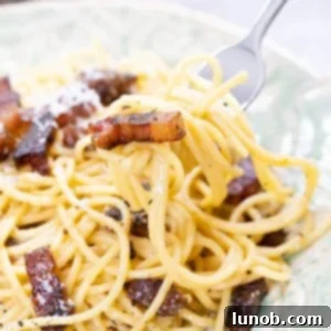 The Art of Perfect Carbonara 19 Spaghetti Carbonara, creamy and topped with crispy guanciale.