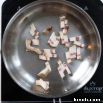 The Art of Perfect Carbonara 4 Guanciale pieces placed in a cold saucepan before cooking.