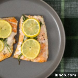 Close-up of crispy skin cast iron lemon dill salmon on a plate.