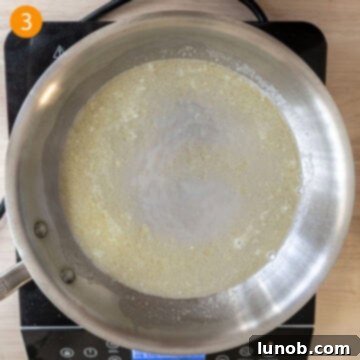 Traditional Roman Fettuccine Alfredo 6 Combining a cup of starchy pasta water with the melted butter in a pan.