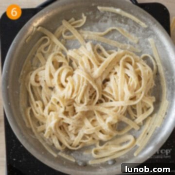 Traditional Roman Fettuccine Alfredo 9 Finished creamy fettuccine alfredo served directly from the pan, garnished with fresh pepper.