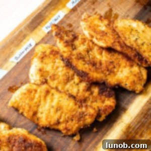 Crispy chicken cutlets neatly arranged on a cutting board, ready to be served.