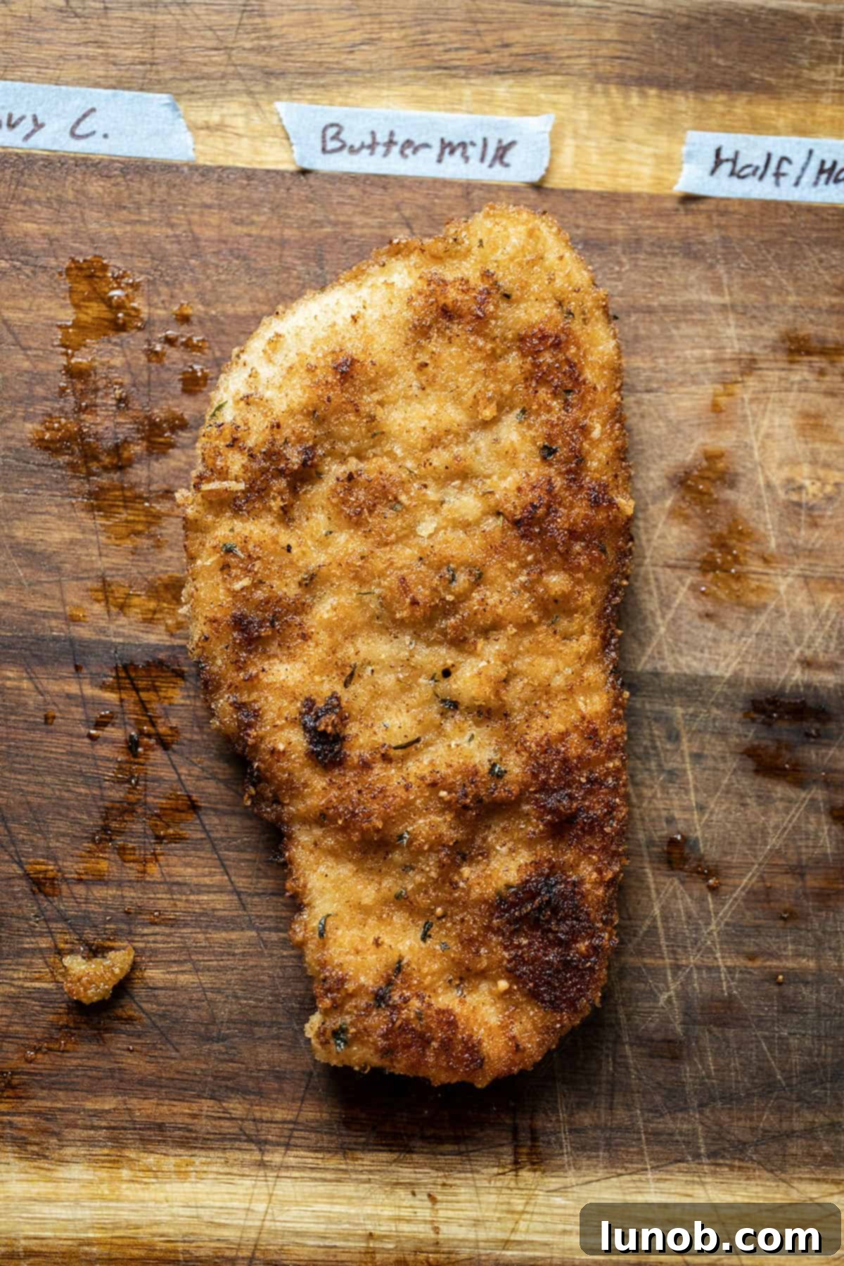 Golden-brown chicken cutlet showing a thick, crispy breading, prepared using buttermilk as a batter.
