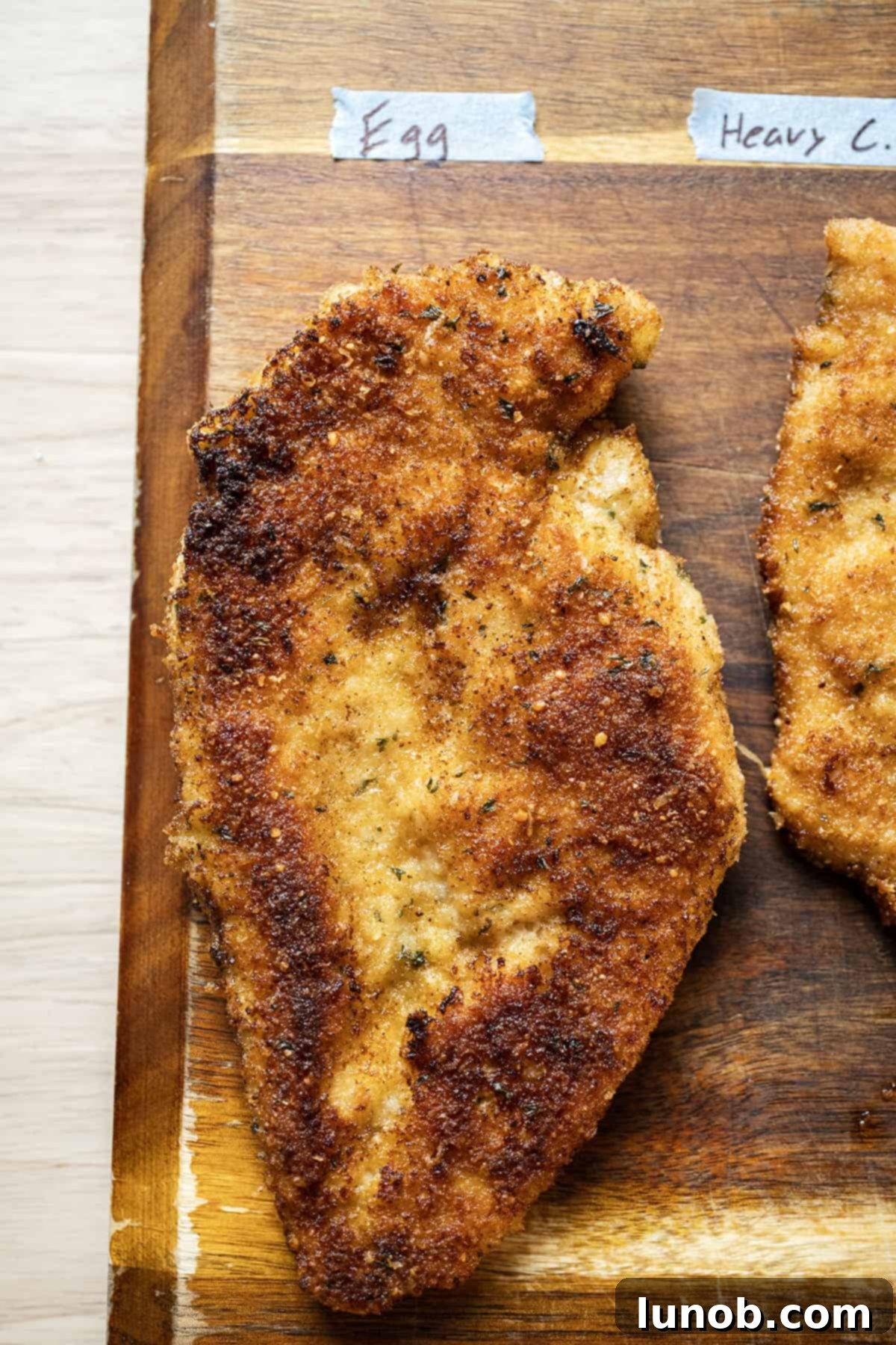 A perfectly golden and crispy chicken cutlet, showing the ideal result of an egg-battered and fried chicken.
