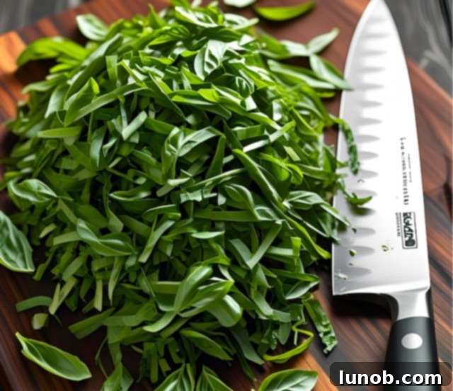 Chiffonade fresh basil into thin strips