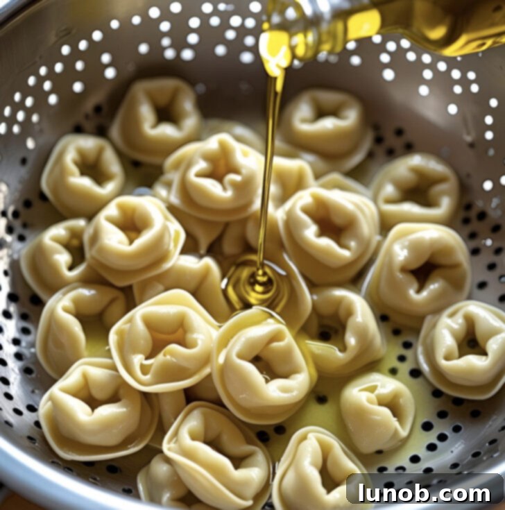 A large serving bowl filled with Italian Tortellini Pasta Salad, ready to be served