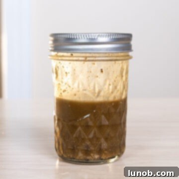 Crispy Pancetta Brussels Sprout Salad 5 Balsamic vinaigrette dressing prepared in a mason jar, ready to be shaken.