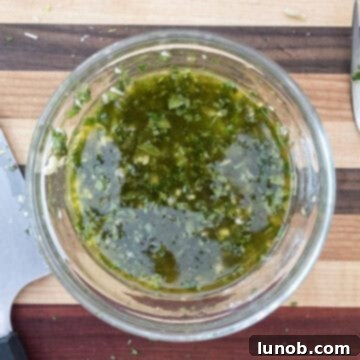 Minty Marinated Zucchini 4 Small bowl containing a freshly whisked mint and garlic vinaigrette dressing.