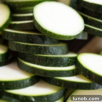 Minty Marinated Zucchini 5 Fresh zucchini sliced into uniform half-inch thick pieces, ready for grilling.