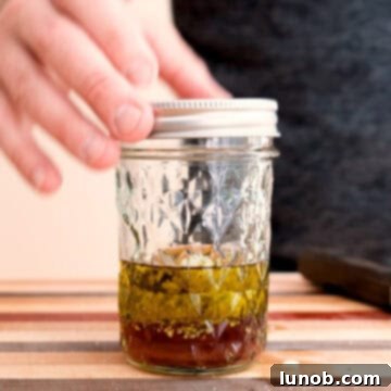 Vibrant Orzo and Chickpea Salad 6 Whisking the salad dressing ingredients in a mason jar.