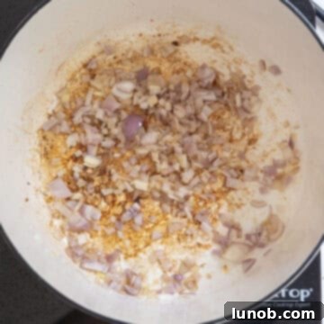 Fiery Chicken Rigatoni 7 Chopped shallots softening and turning translucent in a saucepan with olive oil over medium heat.