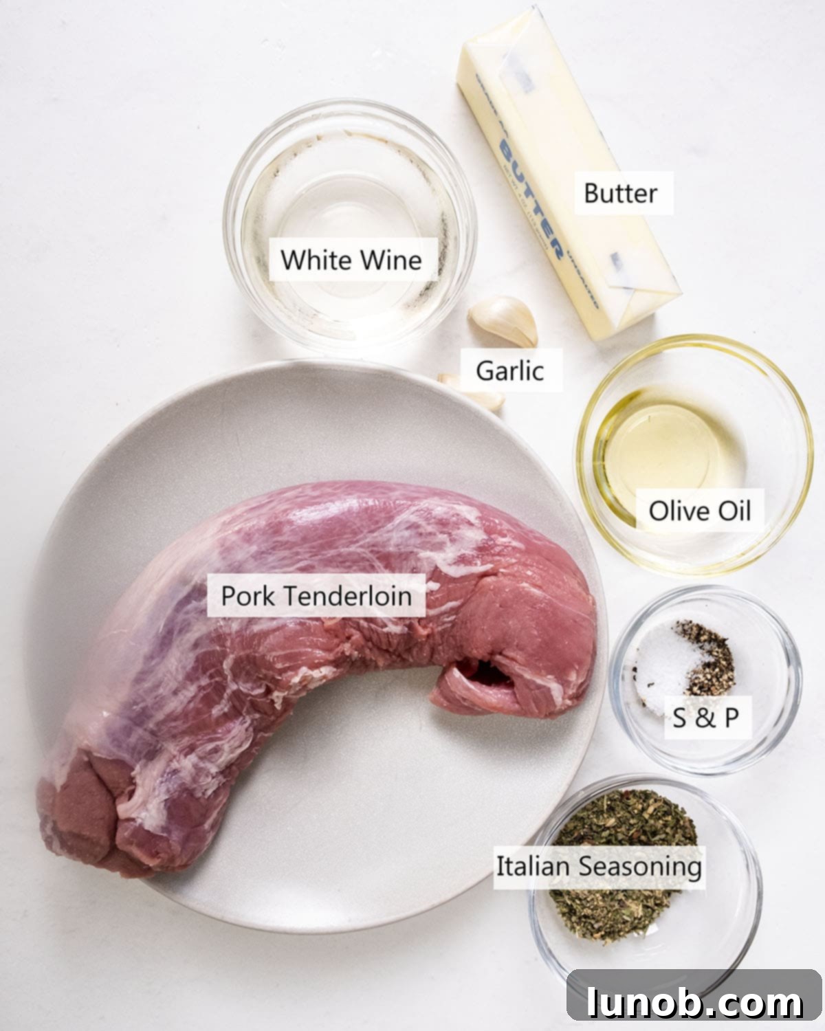 Rustic Italian Cast Iron Pork Tenderloin 3 Fresh ingredients for the cast iron pork tenderloin recipe, including pork tenderloin, herbs, garlic, butter, and wine.