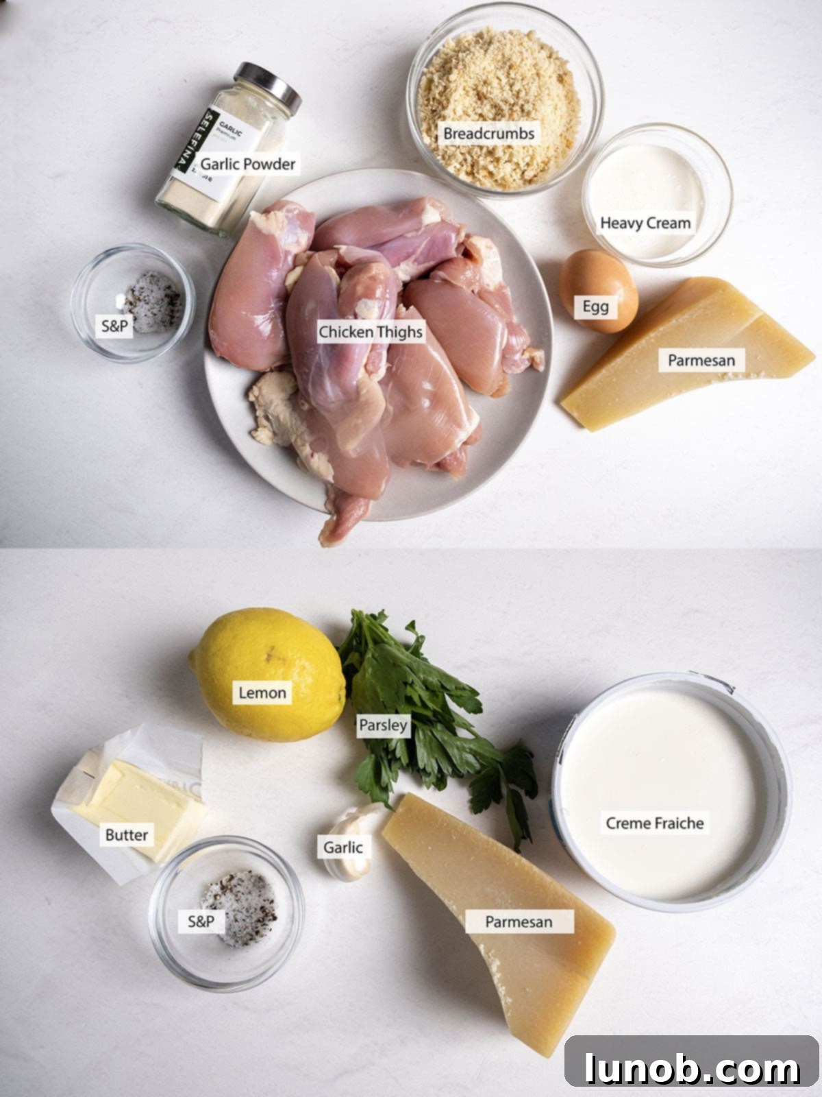 A collection of fresh ingredients laid out for making Air Fryer Parmesan Crusted Chicken Thighs, including raw chicken, panko breadcrumbs, Parmesan cheese, heavy cream, garlic, lemon, and fresh parsley.