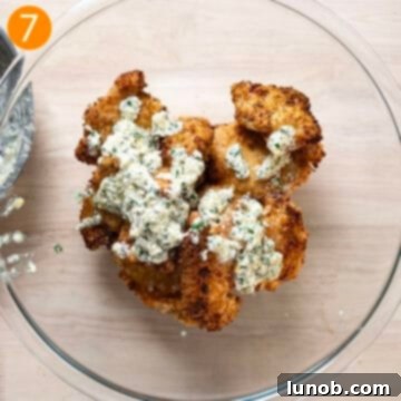Air fried chicken thighs beautifully coated in the creamy garlic sauce, served in a rustic bowl, ready to be enjoyed.