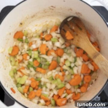 Golden Harvest White Bean Chili 5 Finely chopped celery, onions, and carrots sautéing in olive oil within a Dutch oven, becoming tender and aromatic.