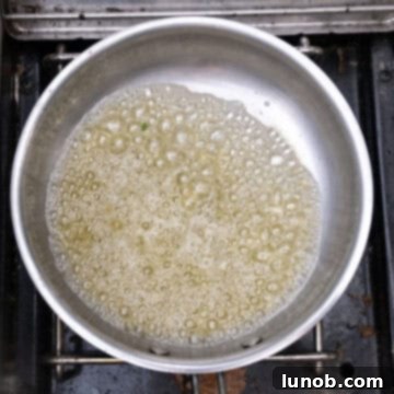 Savory Garlic Parmesan Chicken Skewers 6 Simmering butter and garlic with lemon in a pot.