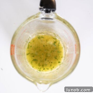 Savory Garlic Parmesan Chicken Skewers 9 Lemon garlic butter sauce in a measuring cup.