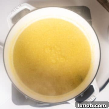 Velvety Golden Polenta 5 Simmering polenta in a dutch oven.