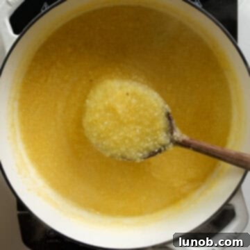 Velvety Golden Polenta 6 Thickening polenta in a pot.