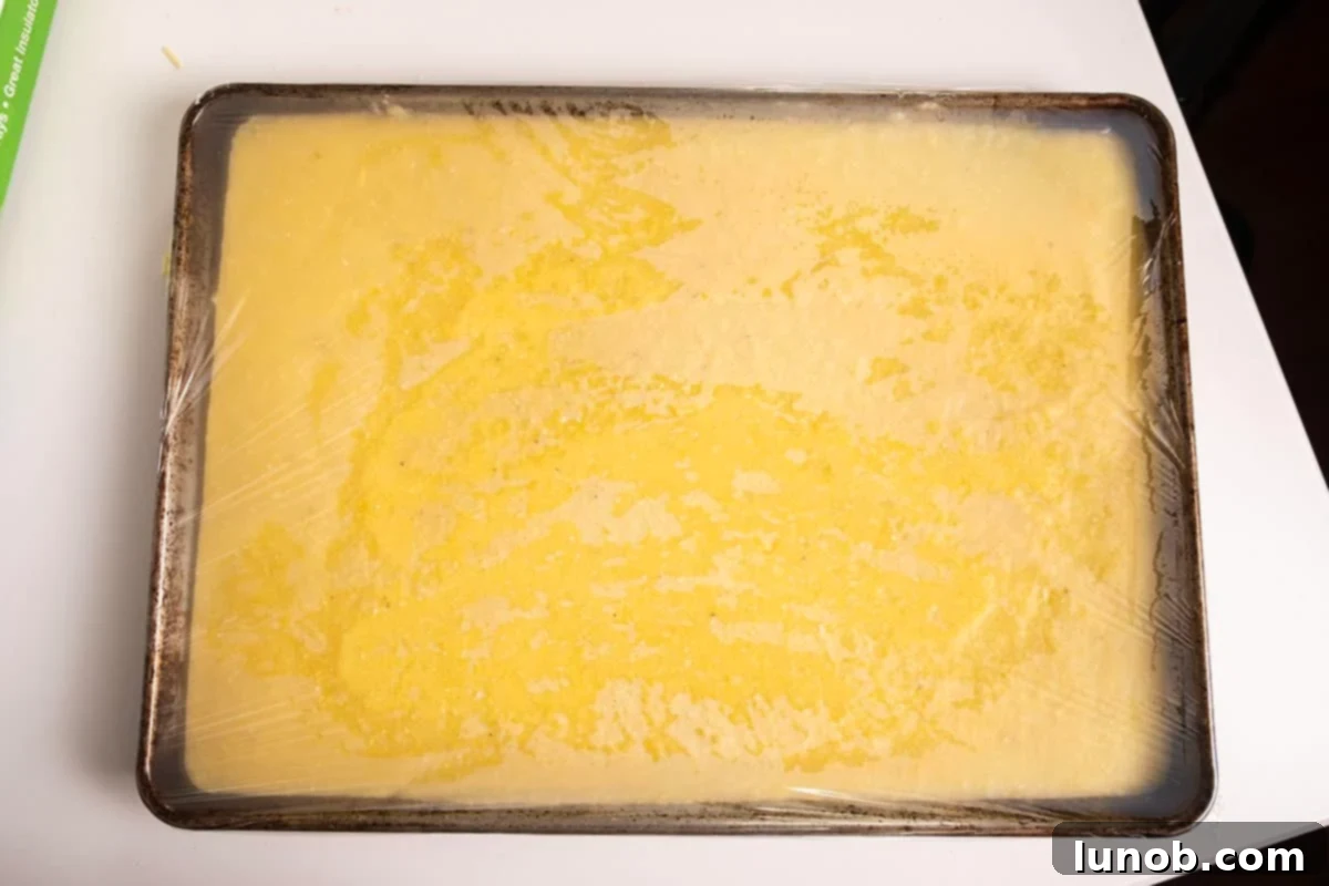 Polenta chilled on a baking sheet.